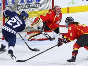 The Mount Royal University Cougars' Andrea Sanderson wasn't able to get this shot past the University of Calgary Dinos goalie Kelsey Roberts during the Crowchild Classic at the Scotiabank Saddledome in Calgary, Thursday January 25, 2018.