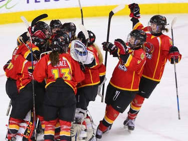The University of Calgary Dinos celebrate defeating the Mount Royal University Cougars 1-0 in the Crowchild Classic at the Scotiabank Saddledome in Calgary, Thursday January 25, 2018.