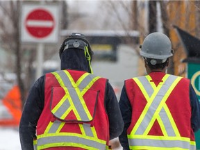 Construction workers walk back to a job site in Calgary's East Village on Wednesday January 30, 2018. Gavin Young/Postmedia