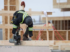 Construction workers build homes in the Mahogany area of southeast Calgary on Wednesday January 30, 2018. Gavin Young/Postmedia
