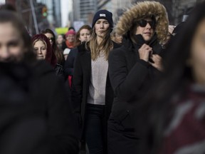 People participate in a Women's March in Toronto on Saturday, Jan. 20, 2018.