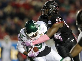 Calgary Stampeders Ja'Gared Davis right, tackles Saskatchewan Roughriders Kevin Glenn during CFL action at McMahon Stadium in Calgary, Alta.. on Friday October 20, 2017. Leah hennel/Postmedia