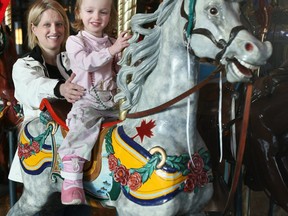 Shannon Shenher and her daughter Ava, 2, ride on the carousel at Chinook Centre Thursday morning. Many malls have undergone multi-million dollar redevelopments to add more amenities for consumers such as expanded food courts, kids zones, and comfortable lounging chairs. Jenelle Schneider/Postmedia