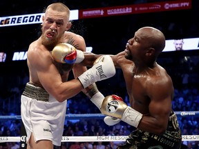 Floyd Mayweather Jr. throws a punch at Conor McGregor during their super welterweight boxing match on August 26, 2017 at T-Mobile Arena in Las Vegas, Nevada. (Christian Petersen/Getty Images)