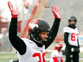 Calgary Stampeders running back Rob Cote stretches with his hands in the air during practice on Nov. 15, 2017