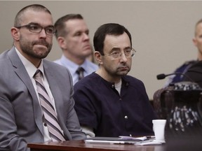 Larry Nassar sits with attorney Matt Newburg during his sentencing hearing Wednesday, Jan. 24, 2018, in Lansing, Mich.  T