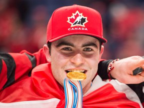 Canada captain Dillon Dubé bites his gold medal after defeating Sweden in gold medal final IIHF World Junior Championships hockey action in Buffalo, N.Y., on Friday, January 5, 2018.