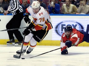 Calgary Flames' Micheal Ferland and Florida Panthers' Aaron Ekblad go for the puck during an NHL game on Jan. 12, 2018