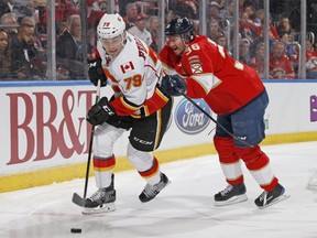 Jussi Jokinen of the Florida Panthers checks Calgary Flames Micheal Ferland on Feb. 24, 2017 in Sunrise, Florida.