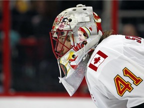 Calgary Flames goaltender Mike Smith (41) eyes the puck during the second period of an NHL hockey game against the Carolina Hurricanes, Sunday, Jan. 14, 2018, in Raleigh, N.C.