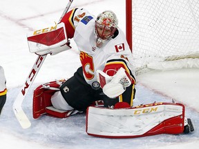Calgary Flames goaltender Mike Smith (41) eyes the puck during the third period of an NHL hockey game against the Carolina Hurricanes, Sunday, Jan. 14, 2018, in Raleigh, N.C. (AP Photo/Karl B DeBlaker) ORG XMIT: NCKD114