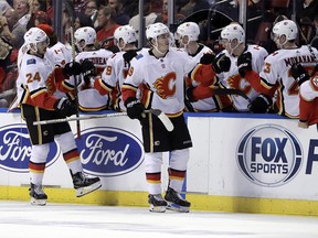 Calgary Flames' Matthew Tkachuk (19) is congratulated after scoring a goal during the second period of the team's NHL hockey game against the Florida Panthers, Friday, Jan. 12, 2018, in Sunrise, Fla. (AP Photo/Lynne Sladky) ORG XMIT: FLLS108