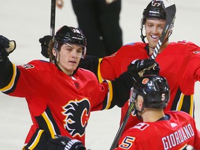 Calgary Flames captain Mark Giordano celebrates with teammates after scoring against the Anaheim Ducks in NHL hockey at the Scotiabank Saddledome in Calgary on Saturday, January 6, 2018.