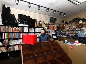 Manager, Ryan Harte looks up at a leaking ceiling at Music Makers at Country Hills Village. The Calgary Fire Department responded to dozens of water-related calls between 7:30 a.m. Monday and 7:30 a.m. Tuesday as temperatures rose.