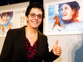 Danielle Goyette of Canadian women's hockey fame checks out her stamp as Canada Post unveiled five stamps to honour six barrier breaking role models at Canada's Sports Hall of Fame in Calgary, Alta., on Wednesday, January 24, 2018.