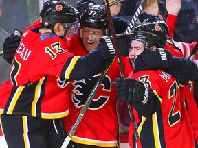Calgary Flames Dougie Hamilton celebrates with teammates after scoring against the Anaheim Ducks in NHL hockey at the Scotiabank Saddledome in Calgary on Saturday, January 6, 2018. Al Charest/Postmedia