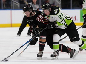 The Edmonton Oil Kings' Trey Fix-Wolansky (right) battles the Calgary Hitmen's Orca Wiesblatt  during second-period WHL action at Rogers Place in Edmonton Monday, Jan. 1, 2018.