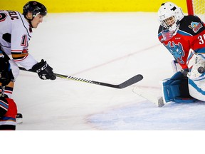 The Kelowna Rockets' Roman Basran makes a save on a shot by Mark Kastelic of the Calgary Hitmen during WHL hockey at the Scotiabank Saddledome in Calgary on Sunday, January 7, 2018.