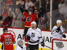 Calgary Flames' Mark Jankowski (77) celebrates his goal behind Los Angeles Kings' Alec Martinez (27) and Trevor Lewis (22) during the second period of their NHL hockey game in Calgary, Thursday, Jan. 4, 2018.THE CANADIAN PRESS/Todd Korol ORG XMIT: TAK110