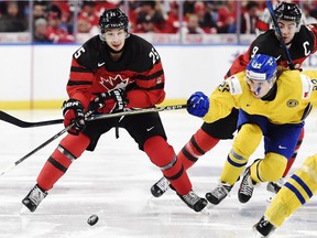 Canada forward Jordan Kyrou (25) carries the puck as Sweden forward Axel Jonsson Fjällby (22) defends during third period gold medal game IIHF World Junior Championship hockey action in Buffalo, N.Y. on Friday, January 5, 2018.