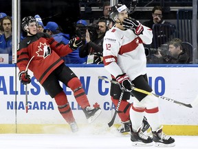 Canada's Drake Batherson (19) celebrates his goal as Switzerland's Tobias Geisser (12) looks on during second period quarter-final IIHF World Junior Championships hockey action in Buffalo, N.Y., on Tuesday, January 2, 2018. THE CANADIAN PRESS/Nathan Denette ORG XMIT: NSD512