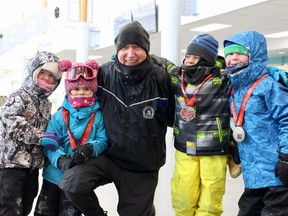 Cochrane's Marathon Man Martin Parnell poses with some young runners 
who participated in a bone-chilling fundraiser New Year's Eve to help build an ice skating rink for girls in Afghanistan. Supplied photo