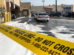 Police tape cordons off the area behind a Wal-Mart store at 1339 Lawrence Ave. W. Toronto Police say a couple found a newborn wrapped in a blanket, lying on the ground Tuesday morning, while temperatures hovered around -6C.