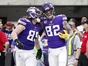 Minnesota Vikings tight end Kyle Rudolph, right, celebrates with teammate David Morgan, left, after catching a 1-yard touchdown pass during the second half of an NFL football game against the Cincinnati Bengals, Sunday, Dec. 17, 2017, in Minneapolis. (AP Photo/Bruce Kluckhohn)