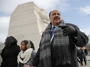 Martin Luther King III, right, with his wife Arndrea Waters, left, and their daughter Yolanda, 9, center, during their visit to the Martin Luther King Jr., Memorial on the National Mall in Washington, Monday, Jan. 15, 2018.
