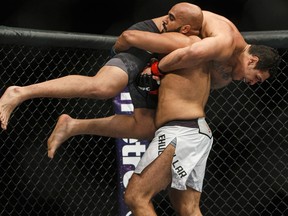 Luis Henrique of Brazil is lifted by Arjan Singh Bhullar of Canada during their bout at UFC 215 in Edmonton on Sept. 9, 2017