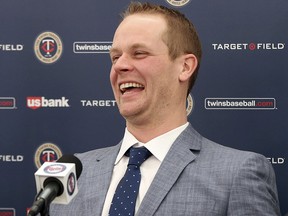 Former Minnesota Twins player Justin Morneau enjoys a light moment during his retirement announcement Wednesday, Jan. 17, 2018 in Minneapolis. (AP Photo/Jim Mone)
