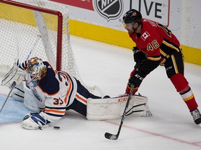 Oilers goalie Cam Talbot makes a save on Flames Marek Hrivik during a preseason game on September 18, 2017. in Edmonton.