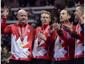 Team Koe skip Kevin Koe, left, waves after receiving his gold medal with third Marc Kennedy, second Brent Laing and lead Ben Hebert during the 2017 Roar of the Rings Canadian Olympic Curling Trials in Ottawa on Dec. 10, 2017. (File)