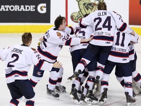 The Regina Pat Canadians jump on goalie Jared Thompson (No. 30) as the Pat Canadians clear the bench in celebration after beating the Red Deer Optimist Chiefs 4-0 in the Mac's AAA Midget Hockey Tournament male gold-medal final game at the Scotiabank Saddledome on Monday, Jan. 1, 2018 in Calgary, Alta.