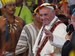 Pope Francis, wearing gifts, leaves after a meeting with representatives of indigenous communities of the Amazon basin from Peru, Brazil and Bolivia, in the Peruvian city of Puerto Maldonado, on Jan. 19, 2018.