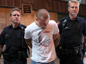 Andrew Jefferson is escorted into arrest processing on Aug. 4, 2006. Jenelle Schneider/Postmedia File