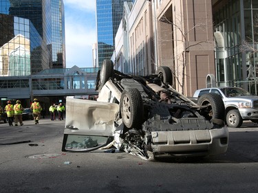 Calgary Police were called out to a vehicle rollover on 9th Avenue and 2nd Street SouthWest. The male driver was taken to hospital in life threatening condition. Wednesday, January 17, 2018. Dean Pilling/Postmedia