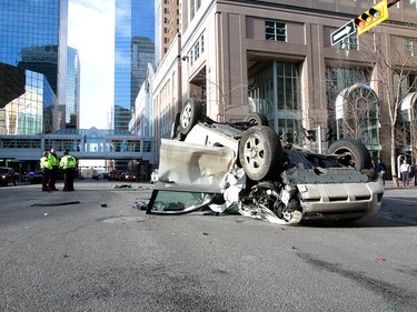 Calgary Police were called out to a vehicle rollover on 9th Avenue and 2nd Street SouthWest. The male driver was taken to hospital in life threatening condition. Wednesday, January 17, 2018. Dean Pilling/Postmedia