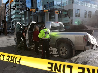 Calgary Police were called out to a vehicle rollover on 9th Avenue and 2nd Street SouthWest. The male driver was taken to hospital in life threatening condition. Wednesday, January 17, 2018. Dean Pilling/Postmedia