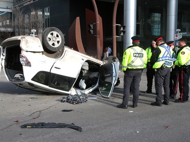 Calgary Police were called out to a vehicle rollover on 9th Avenue and 2nd Street SouthWest. The male driver was taken to hospital in life threatening condition. Wednesday, January 17, 2018. Dean Pilling/Postmedia