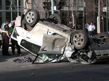 Calgary Police were called out to a vehicle rollover on 9th Avenue and 2nd Street SouthWest. The male driver was taken to hospital in life threatening condition. Wednesday, January 17, 2018. Dean Pilling/Postmedia