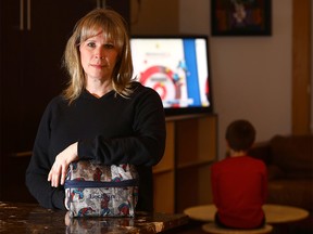 Mom, Roxanne Dunlop with her son Lochlan,7, is not happy after she found out the students at William Reid Elementary, a K-4 public school in Calgary have been watching Netflix cartoons at lunch in their classrooms, no longer able to socialize with friends in the gym as they were doing last year. on Thursday January 18, 2018. Darren Makowichuk/Postmedia