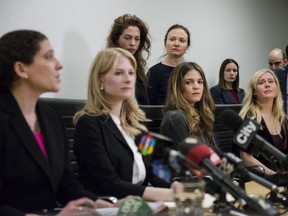 Lawyers Alexi Wood (left) and Tatha Swann (second from left) and plaintiffs Hannah Miller, Patricia Fagan, Diana Bentley and Kristin Booth attend a press conference after filing lawsuits alleging sexual harassment by Soulpepper Theatre Company director Albert Schultz, in Toronto, on Thursday, January 4, 2018.