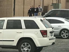 Police escort a person, second from right, out of the Marshall County High School after a shooting there on Tuesday, Jan 23, 2018, in Benton, Ky. Gov. Matt Bevin said two people were killed and 19 injured in the shooting.