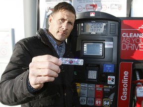Sean Sportun of the Canadian Crime Stoppers Association holds up new anti-skimming decals that will be installed on gas pumps around the city in an effort to help curb fraud and theft at the pump. Monday, January 22, 2018.