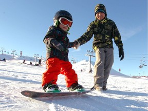 A youngster gets a helping hand while learning to snowboard at WInsport (Canada Olympic Park) in Calgary, Alta on Sunday January 15, 2017.