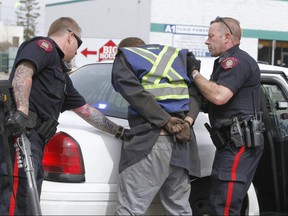 Calgary Police take a man into custody in the southeast in allegedly in connection to a stolen vehicle in Calgary Alta on Saturday April 22, 2017. The stolen vehicle was stolen in similar fashion to a sports car on Friday. Jim WellsPostmedia