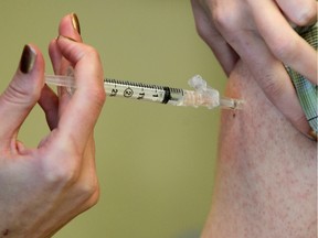 The flu vaccine is administered at an Alberta Health Services immunization clinic in Sundance.