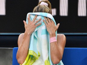 Italy's Camila Giorgi rests during a women's singles second round match against Australia's Ashleigh Barty at the Australian Open on Jan. 18, 2018