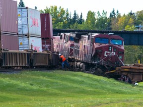 Crews inspect the scene after a Canadian Pacific train collided with the rear of a stopped train in Alyth yard on Sept. 3, 2016.